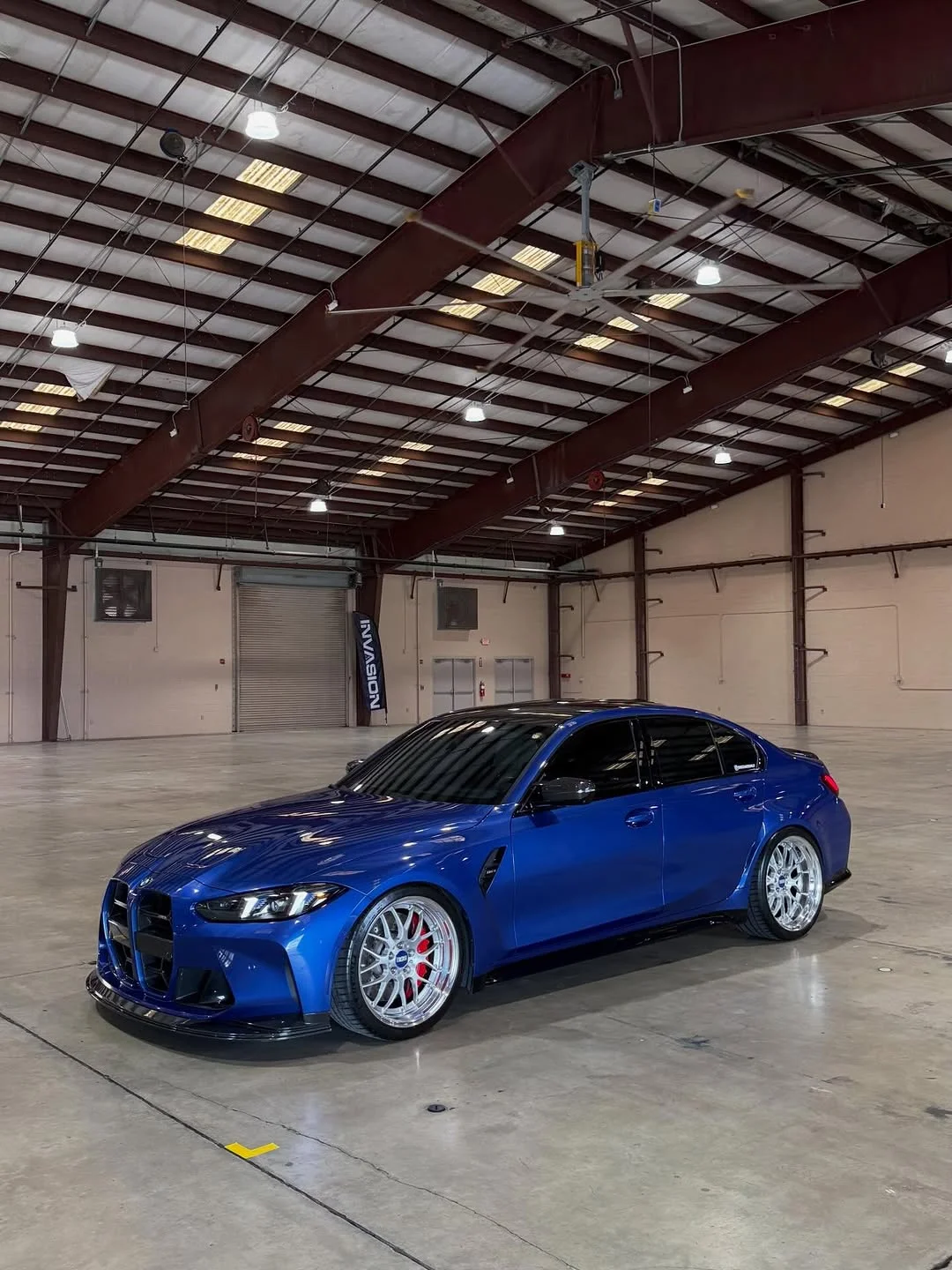 Blue G80 M3 inside an empty warehouse